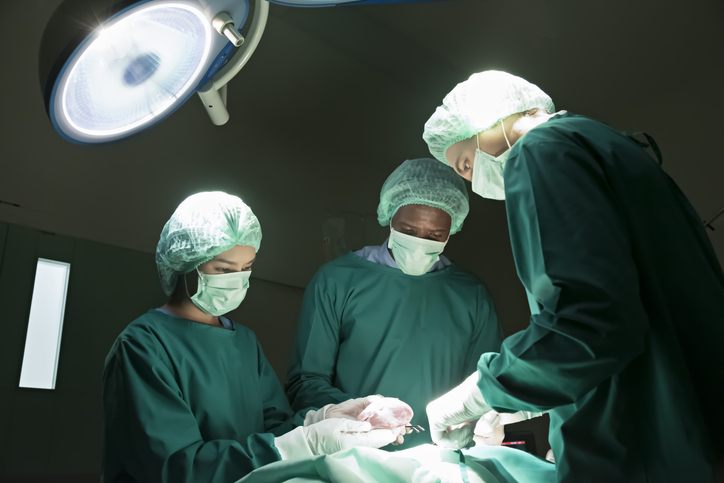Surgeons are performing heart transplant operation for a serious patient.