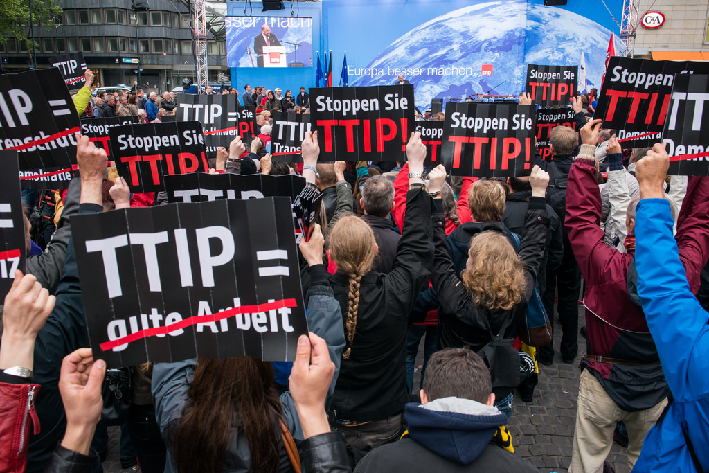TTIP protestors hold up signs during a flashmob during a visit from Martin Schulz to the German city of Dortmund. May 2014 [campact/Flickr]