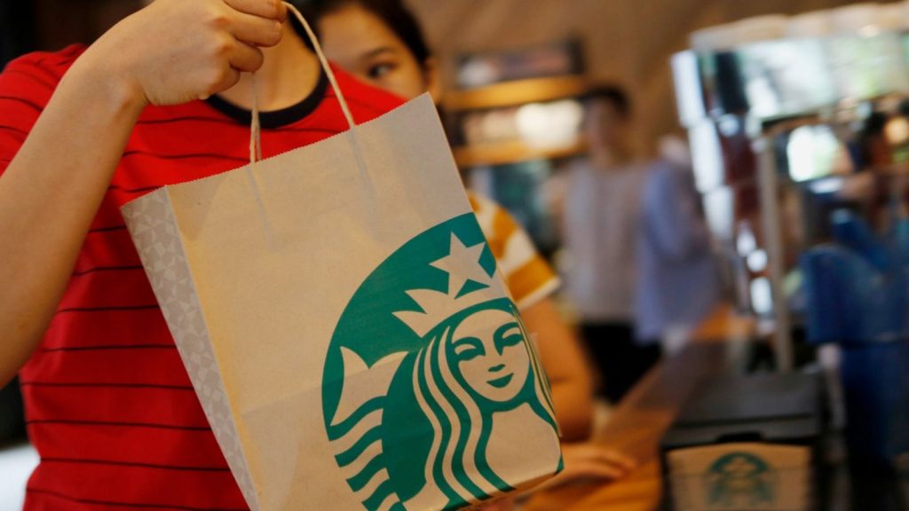 epa05988422 A customer carries her ordered drinks in a Starbucks cafe, in Phnom Penh, Cambodia, 25 May 2017. The cafe is Starbucks first opened and operated in Cambodia.  EPA/KITH SEREY