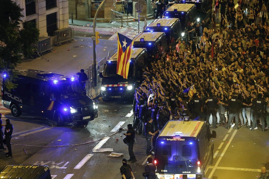 Catalonian Police members protect National Police vehicles