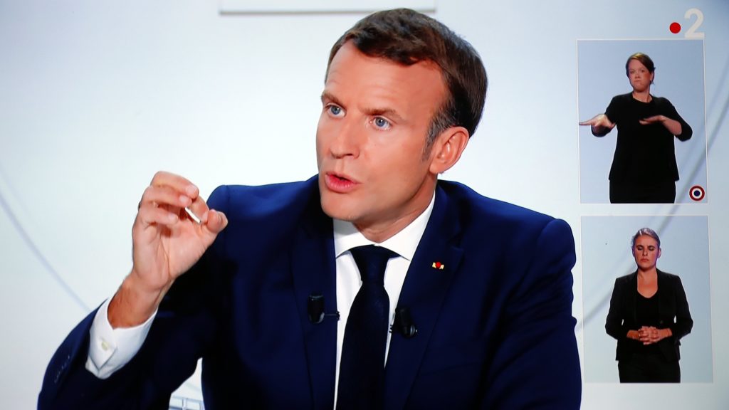 epa08744979 A picture of TV screen shows French President Emmanuel Macron speaking during an interview on the situation of the COVID-19 outbreak, caused by the novel coronavirus, in Vendemian, France, 14 October 2020. Macron asked the french citizens to reduce their movement and establish a curfew from 17 October 2020.  EPA-EFE/Guillaume Horcajuelo
