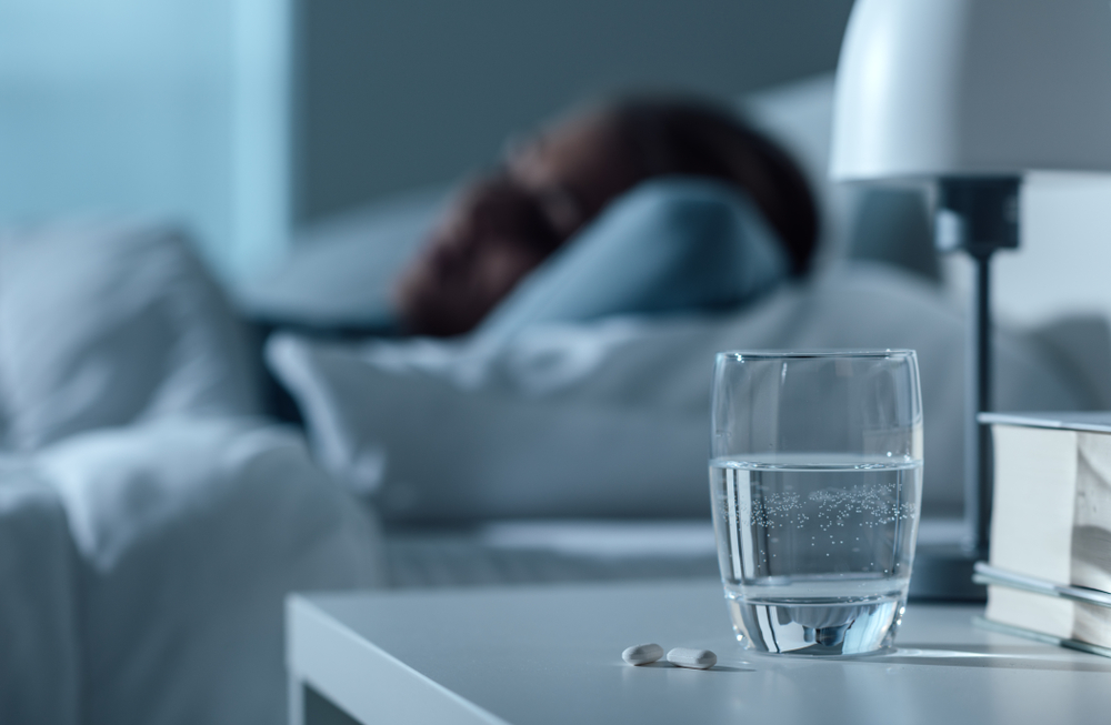 Woman,Sleeping,In,Her,Bed,At,Night,,Glass,On,Water