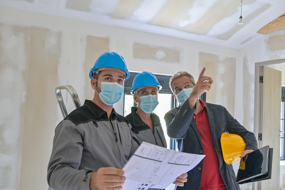 Professional,Meeting,On,A,Construction,Site,Between,The,Architect,And