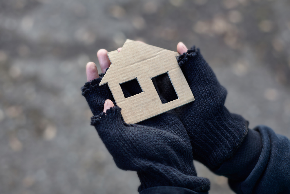 Young,Homeless,Boy,Holding,A,Cardboard,House