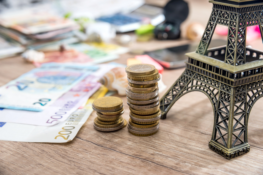 Eiffel,Tower,With,Euro,Money,On,Desk.,Travel,Concept.