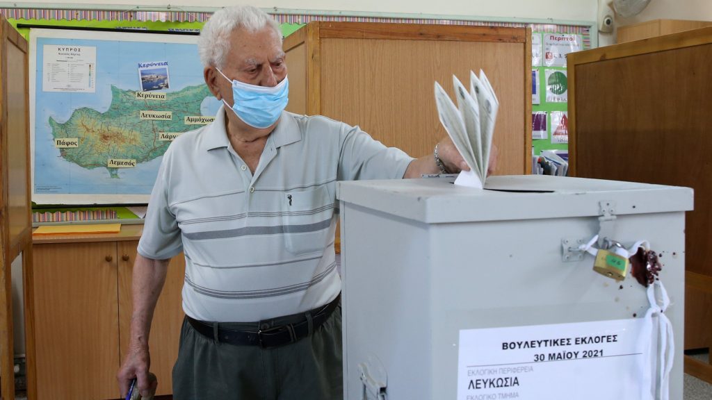 epaselect epa09236447 A Greek Cypriot man wearing a protective face mask casts his vote in the parliamentary elections at a polling station in Nicosia, Cyprus, 30 May 2021. Cypriots go to the polls organized amid coronavirus COVID-19 pandemic to elect a new House of Representatives of the Republic of Cyprus for the next five years.  EPA-EFE/KATIA CHRISTODOULOU