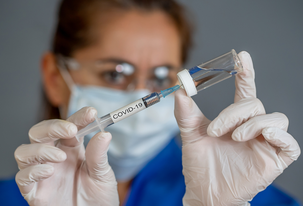 Covid-19,Coronavirus,Vaccine.,Doctor,Scientist,With,Syringe,Analyzing,Virus,Sars-cov-2