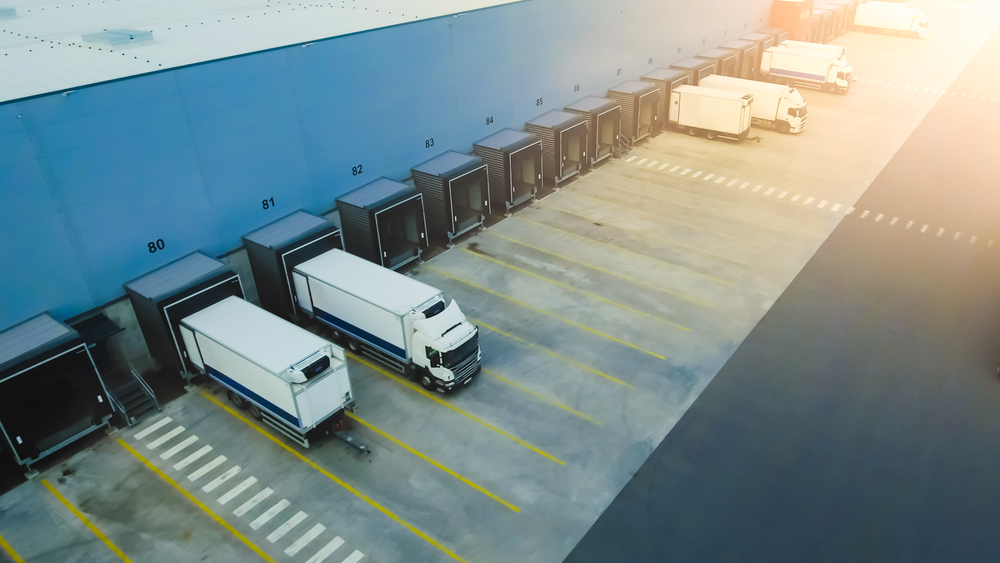 Aerial,Shot,Of,Industrial,Warehouse,Loading,Dock,Where,Many,Truck