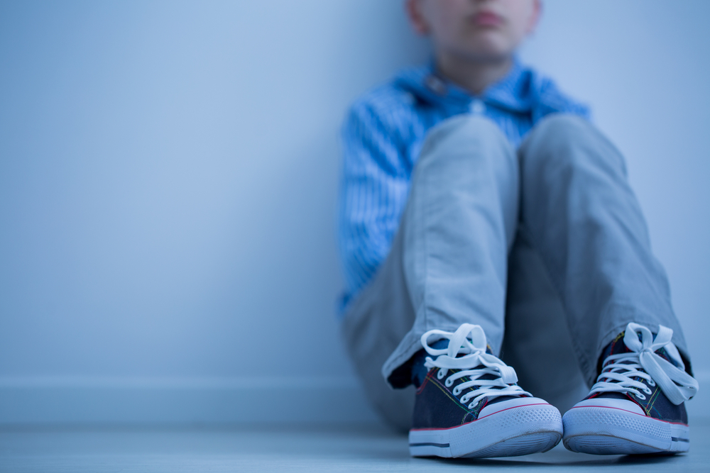 Sad,Boy,In,Sneakers,With,Asperger&rsquo;s,Syndrome,Sits,Alone,In