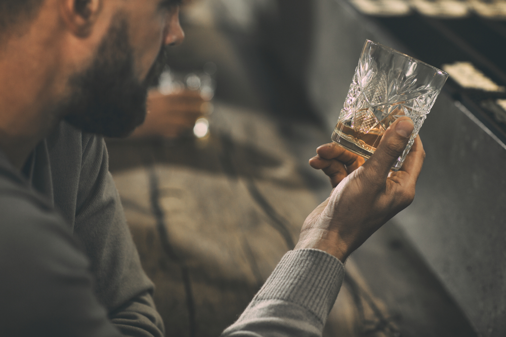Close,Up,Of,Man&rsquo;s,Hand,Holding,Crystal,Glass,Of,Whiskey