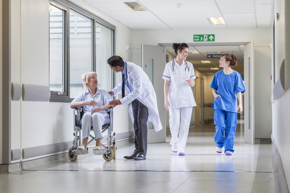 Senior,Female,Woman,Patient,In,Wheelchair,Sitting,In,Hospital,Corridor