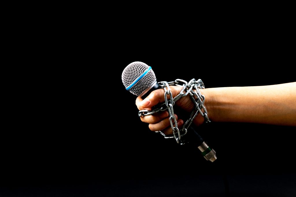 World,Press,Freedom,Day,Concept.,Woman,Hand,With,Microphone,Tied