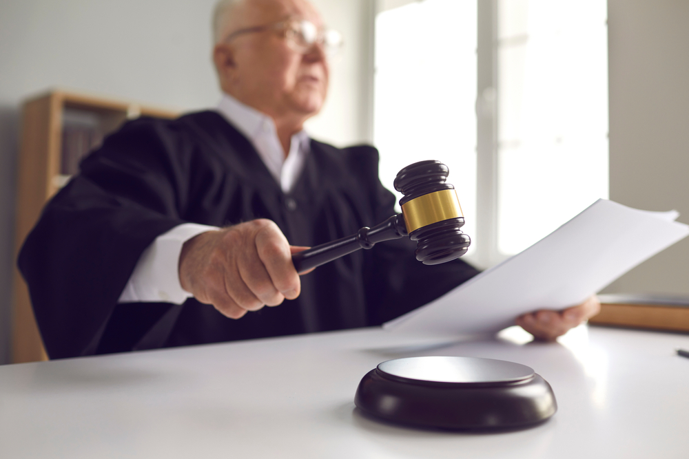 Stern,Judge,With,Paper,Document,Pronouncing,Sentence,In,A,Court
