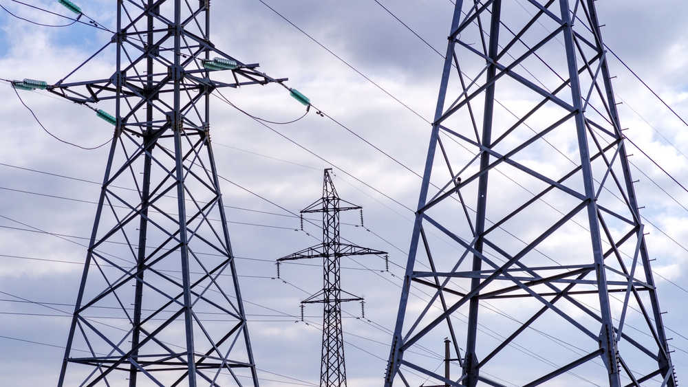 Several,High-voltage,Towers,Against,A,Cloudy,Sky.,Power,Lines.,Horizontal