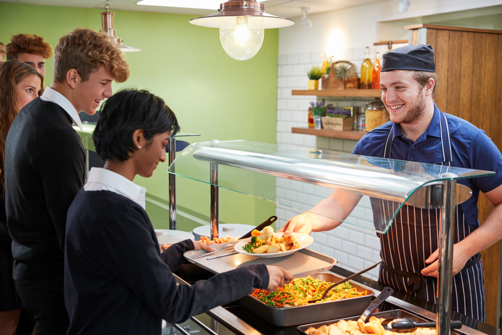 Teenage,Students,Being,Served,Meal,In,School,Canteen