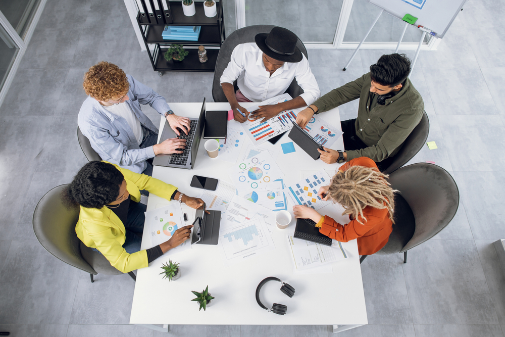 Top,View,Of,Five,International,Business,People,Sitting,Together,At