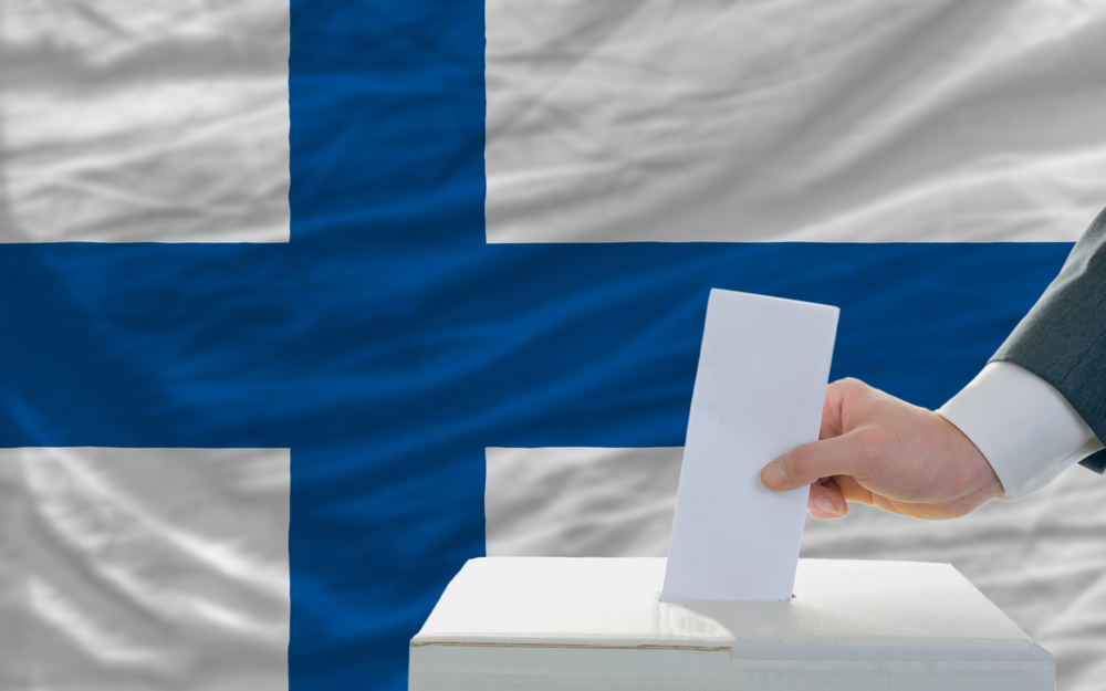 Man,Putting,Ballot,In,A,Box,During,Elections,In,Finland