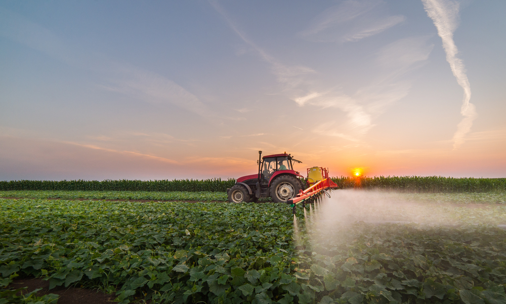 Tractor,Spraying,Pesticides,On,Vegetable,Field,With,Sprayer,At,Spring