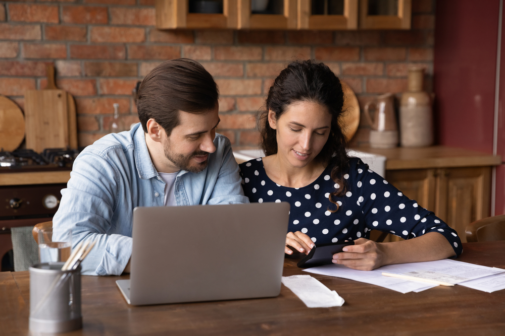 Smiling,Millennial,Man,And,Woman,Use,Laptop,Pay,Bills,Taxes