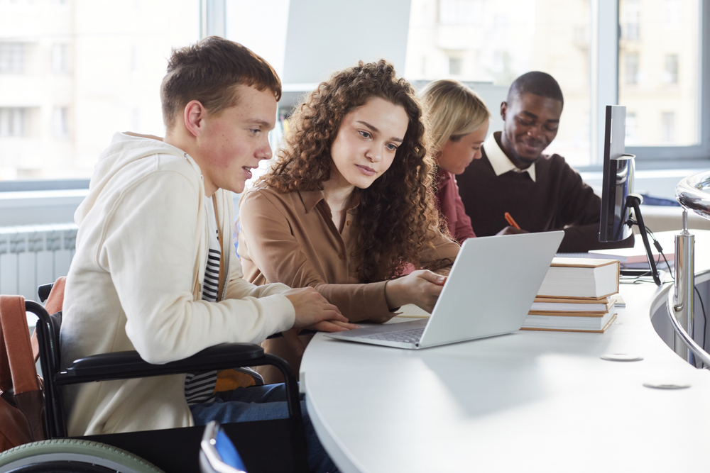 Side,View,At,Multi-ethnic,Group,Of,Students,Using,Laptop,While