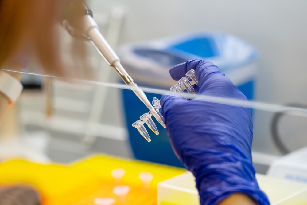 Scientist,Pipetting,Sample,Into,Vial,For,Dna,Testing.,Scientist,Loads