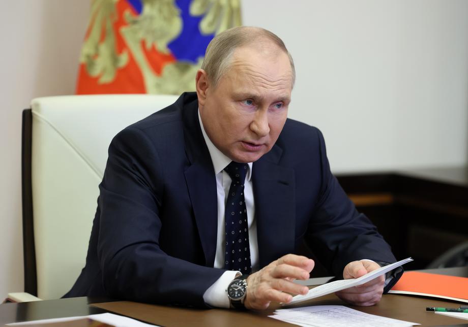 Russian President Vladimir Putin chairs a meeting with members of the Russian Security Council
