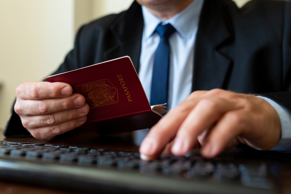 Close,Up.,The,Immigration,Control,Officer,Verifies,Passport,Identification,Data.