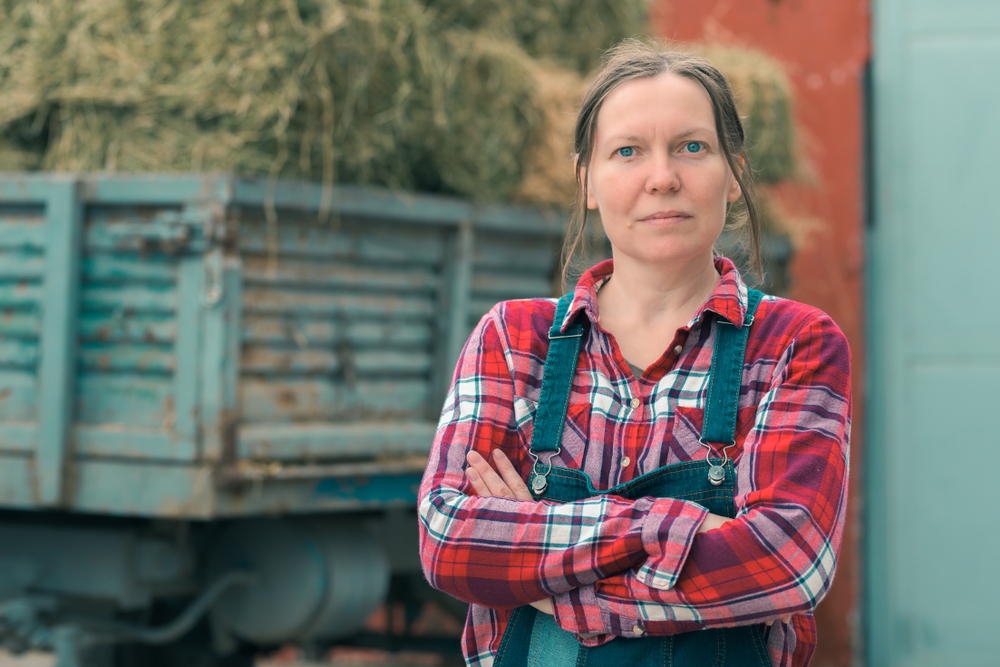 Female,Farmer,Posing,In,Front,Of,Hay,Wagon.,Portrait,Of