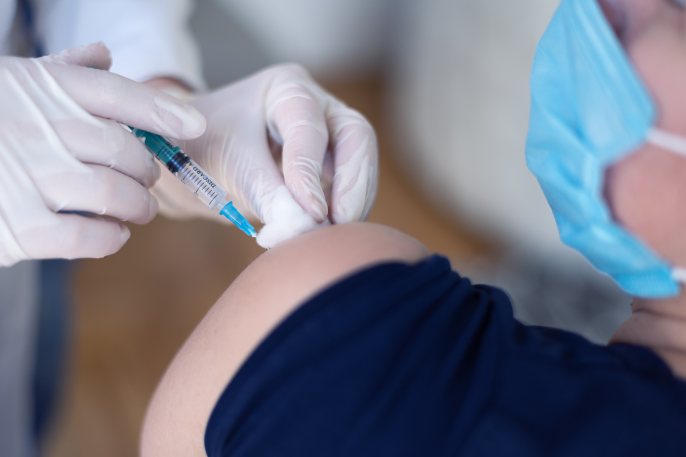 Young,Female,Doctor,In,Protective,Mask,Injecting,Or,Prepairing,For