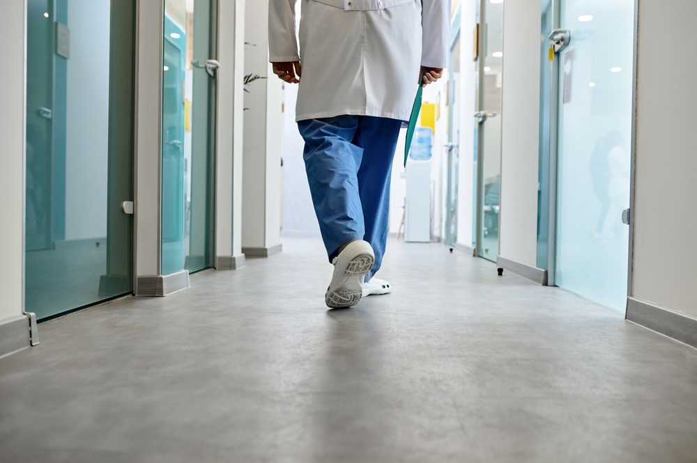 Doctor,Walking,In,Hospital,Corridor,Rear,View
