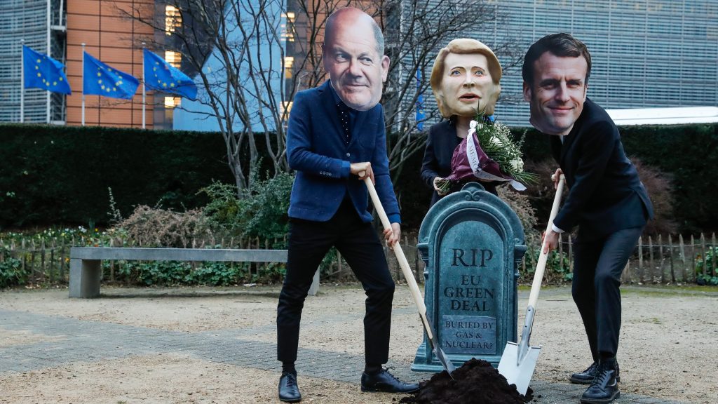 epa09722568 A puppet resembling to European Commission President Ursula von der Leyen surrounded by men wearing masks of German Chancellor Olaf Scholz and French President Emmanuel Macron gather around a pretended Green Deal grave to protest against European Commission decision to label gas and nuclear energy &lsquo;sustainable&rsquo;, in Brussels, Belgium, 02 February 2022. Activists are protesting against the EU classification system known as taxonomy after a European Commission proposal to label nuclear energy and natural gas as sustainable under this taxonomy.  EPA-EFE/STEPHANIE LECOCQ