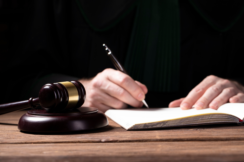 A,Lawyer,Looking,At,The,Penal,Code,With,Magnifying,Glass