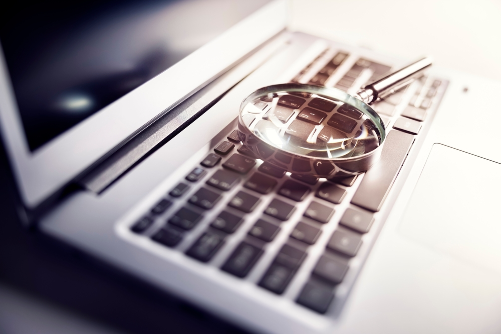 Magnifying,Glass,On,Laptop,Keyboard,Searc,For,Online,Documents,Background