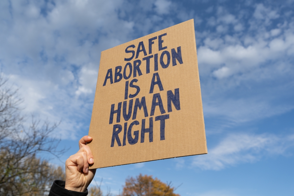 Woman,Hand,Holding,Sign,With,Slogan,Safe,Abortion,Is,A