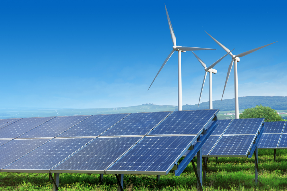 Solar,Panels,And,Wind,Turbines,Under,Blue,Sky,On,Summer