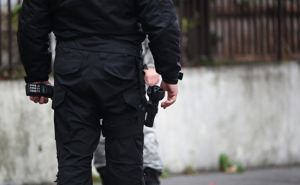 Policeman,With,A,Pistol,In,A,Belt,Stands,At,The