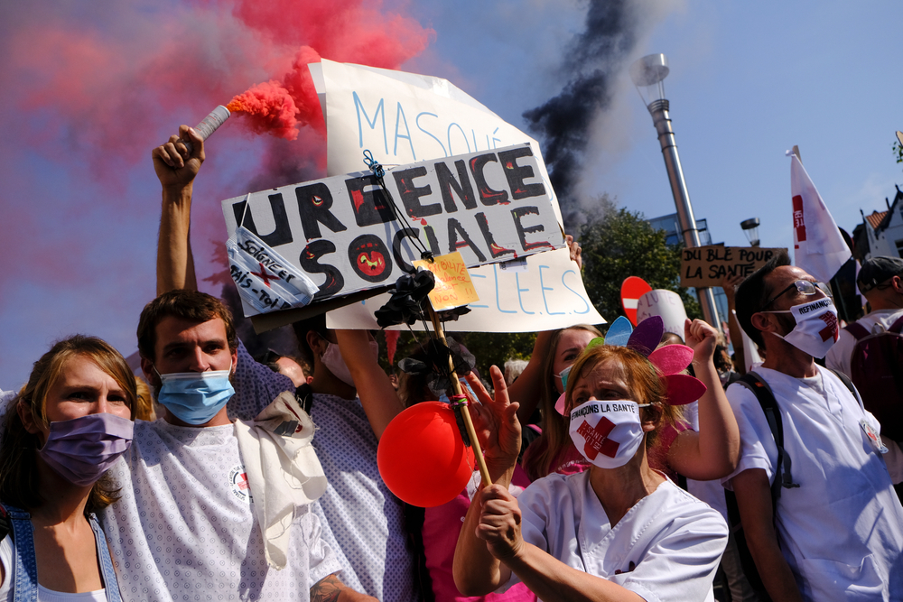 People,Wearing,Face,Masks,Carry,Placards,During,A,Health,Sector