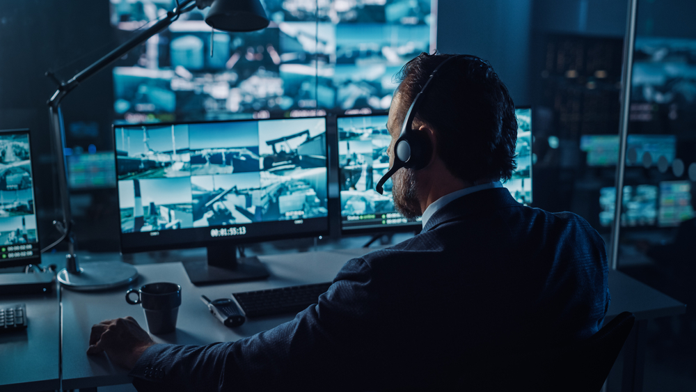 Male,Officer,Works,On,A,Computer,With,Surveillance,Cctv,Video