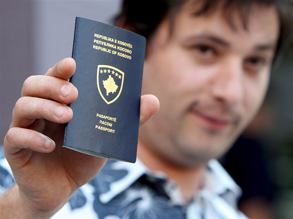 A Kosovar Albanian man shows his newly issued Kosovo passport in Kosovo&rsquo;s capital Pristina