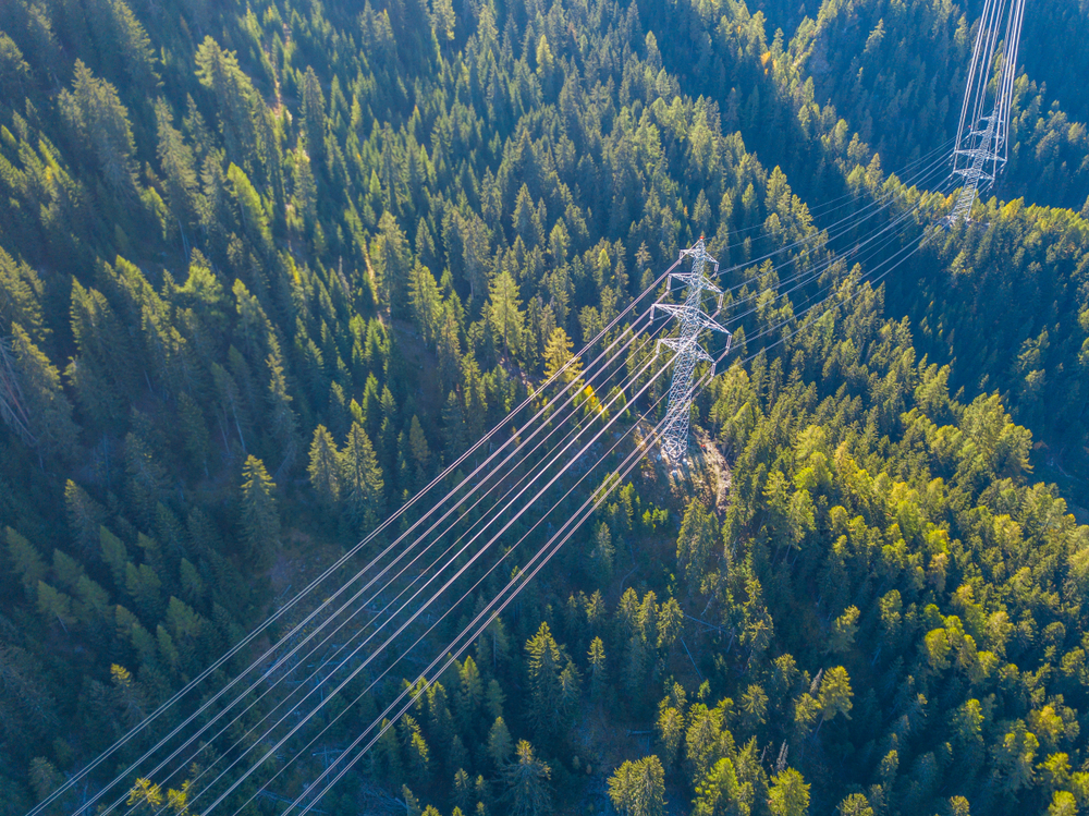 Aerial,View,Of,Power,Line,Pylon,In,Mountaineous,Area,In