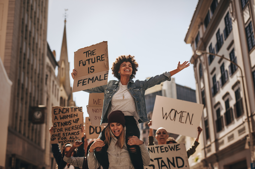 Group,Of,Female,Protesters,Marching,On,The,Road,With,Signboards