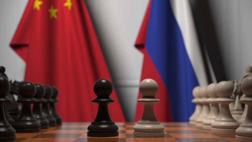 Flags,Of,China,And,Russia,Behind,Chess,Board.,The,First