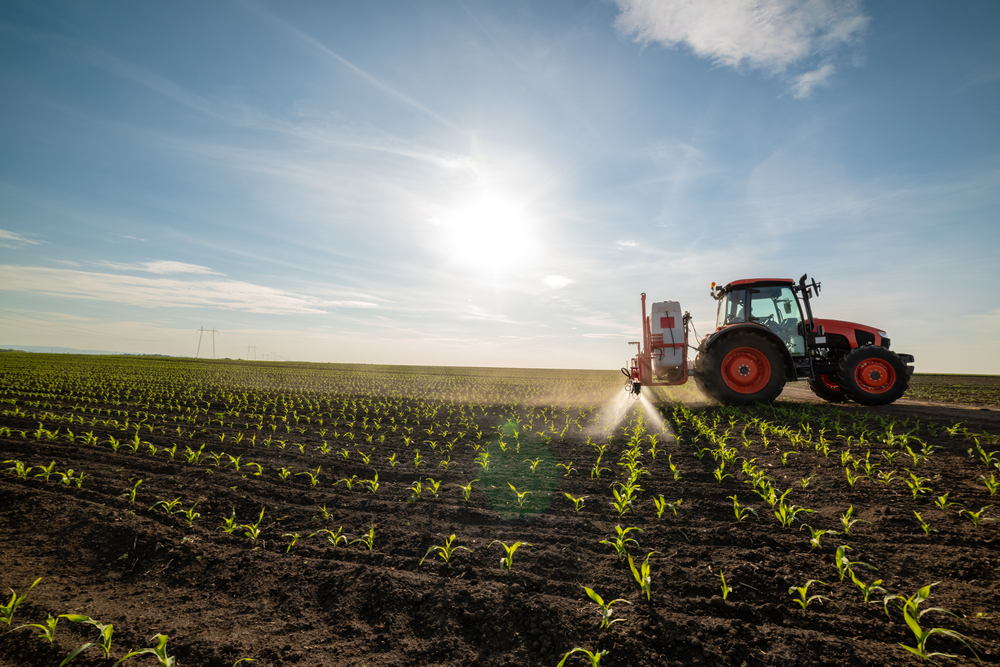 Tractor,Spraying,Young,Corn,With,Pesticides