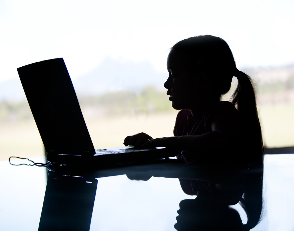 A,Silhouette,Of,A,Young,Girl,On,The,Computer,May