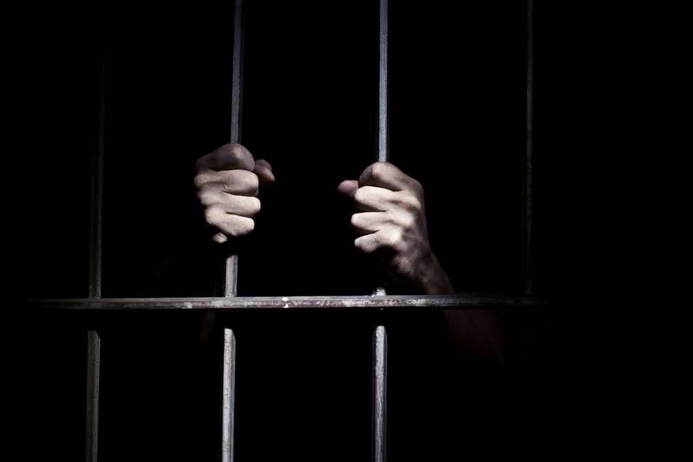 Hands,Of,The,Prisoner,On,A,Steel,Lattice,Close,Up