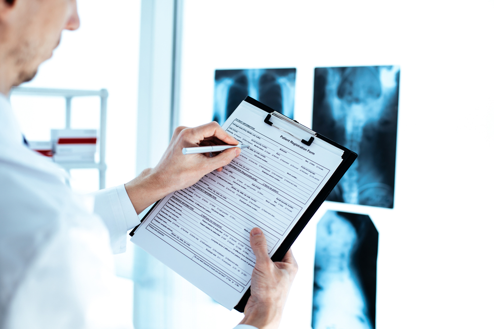 Doctor,Is,Making,Entries,In,The,Patient&rsquo;s,Registration,Form.