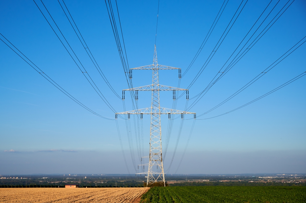 Power,Pole,In,A,Field,In,Front,Of,The,Blue