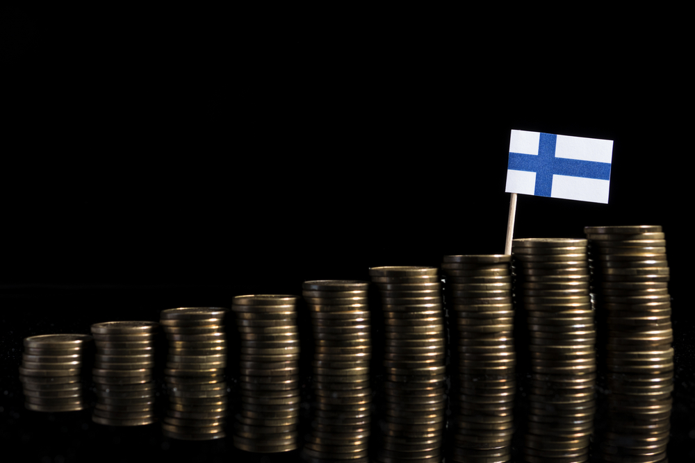 Finnish,Flag,With,Lot,Of,Coins,Isolated,On,Black,Background
