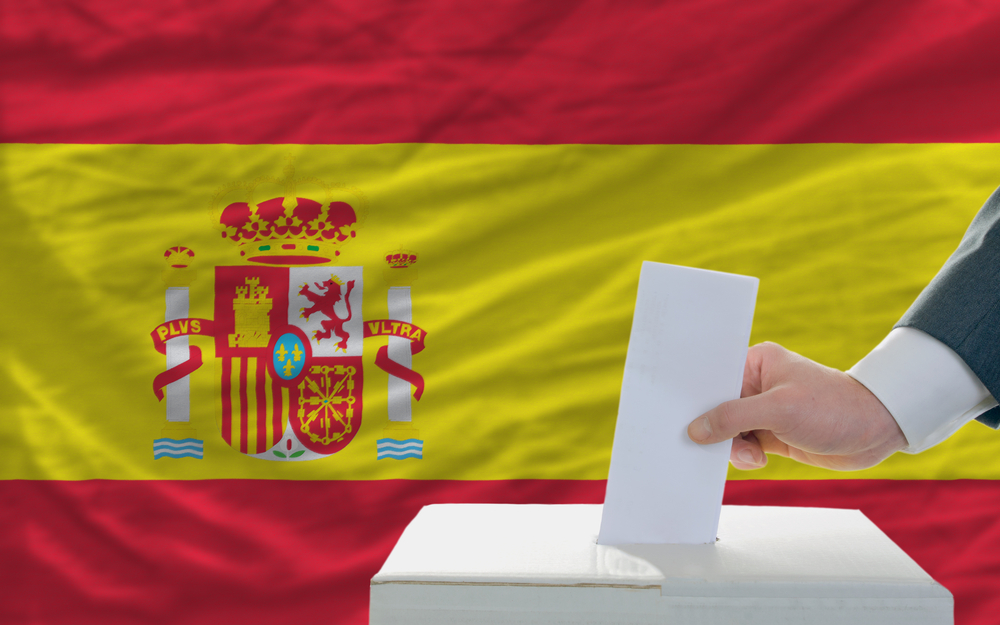 Man,Putting,Ballot,In,A,Box,During,Elections,In,Spain