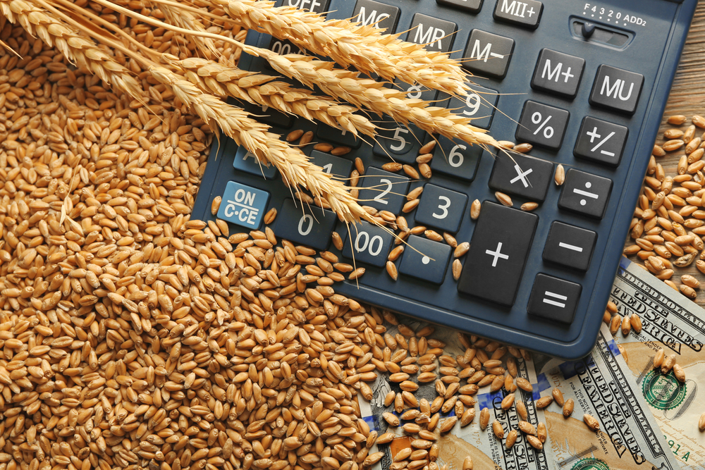 Dollar,Banknotes,,Calculator,And,Wheat,Grains,On,Wooden,Background.,Agricultural